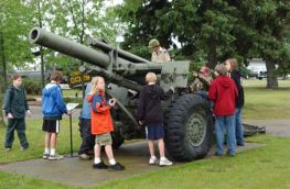 A Scout group checks out a 155mm M114 howitzer.