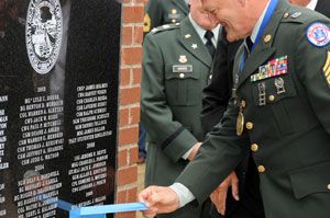 An honoree removes the tape from the monument marking his name in the Court of Honor, 2009.