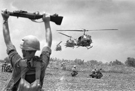 An American soldier uses an M79 Grenade Launcher to guide helicopters into an operation in South Vietnam's Mekong Delta, July 1968. (Henri Huet/AP)