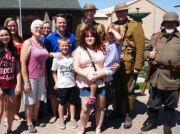 Visitors pose with World War I re-enactors during opening day of a new special exhibit
