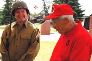 A WWII re-enactor meets a WWII Vet at the opening event for a new exhibit.