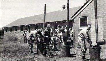 Swabbing mess trays, three times a day when not in the field, about 1950.